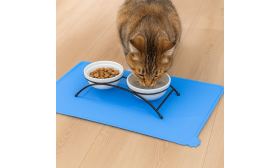 Waterproof silicone cat feeding mat in blue, made from safe, non-toxic material, fits cat food and water bowls perfectly.